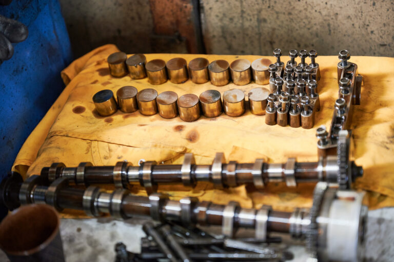 Steel cogs, details, equipment used by workers, repairmen. Engineers, mechanics working in garage, workshop, repairing, fixing cars. Concept of manual labor.